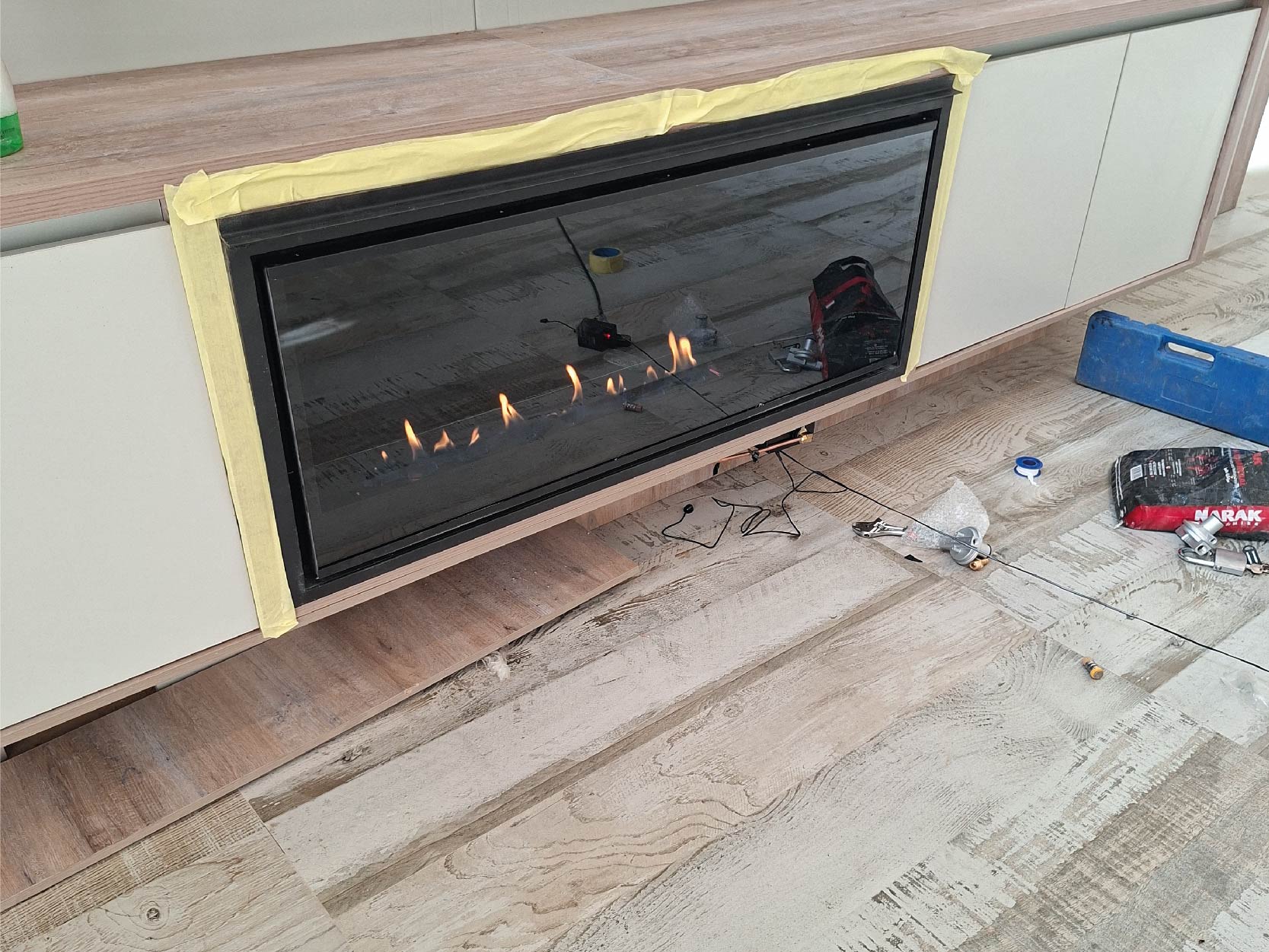 Family enjoying warm gas fireplace in modern home